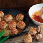 A visually appealing comparison of meatballs and meatloaf. On the left, a plate of perfectly round, golden-brown meatballs garnished with fresh parsley, served alongside marinara sauce in a small bowl